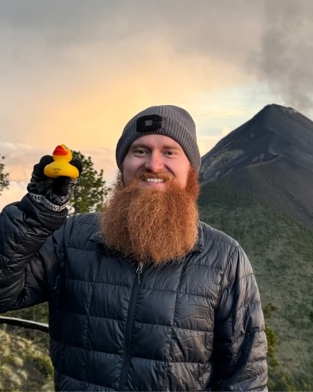 Thomas Meade outdoors, wearing a travel jacket